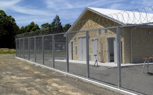 a perimeter fenced surrounds a building  for security